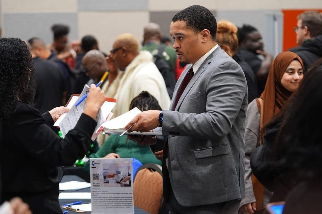 Photo of a job seeker listening to information about employment during a job fair in Dallas